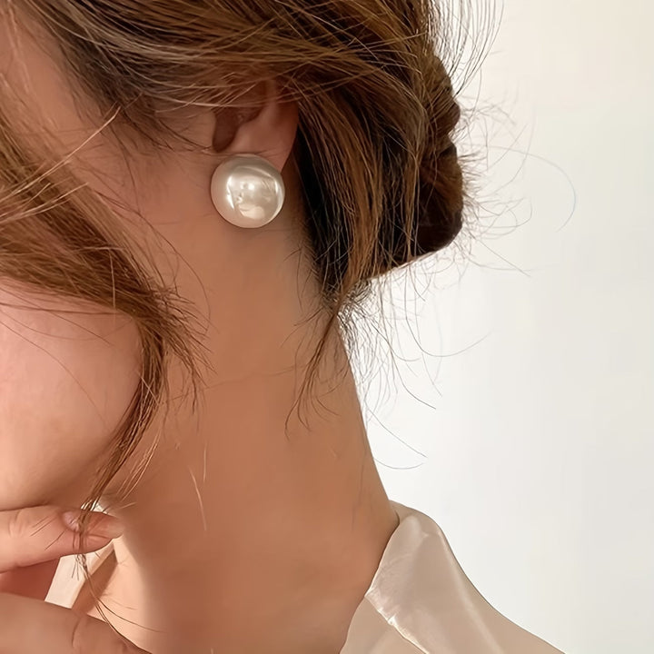 Les boucles d'oreilles dormeuses à perle statement