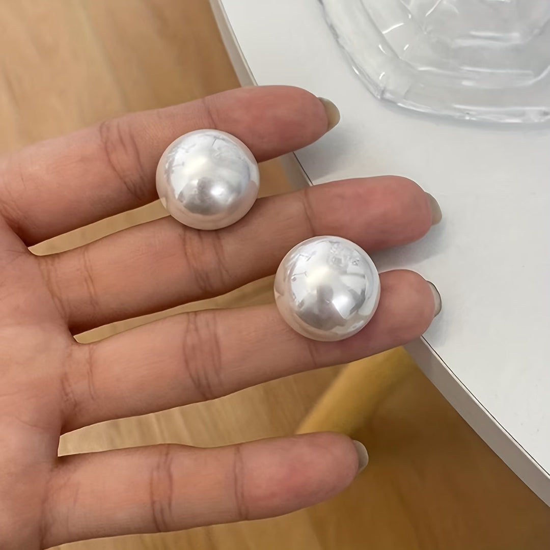 Les boucles d'oreilles dormeuses à perle statement