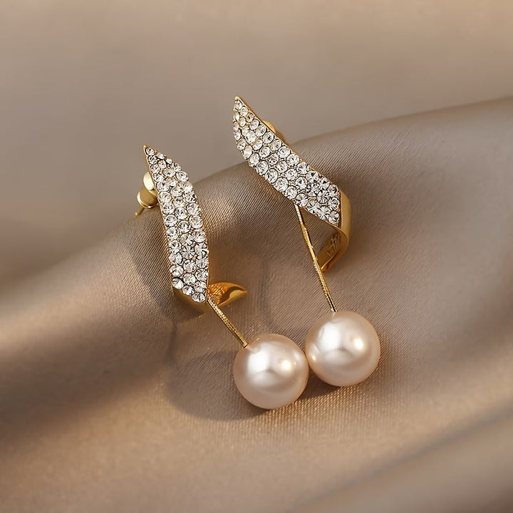 Boucles d'oreilles en perle avec plume en cristal