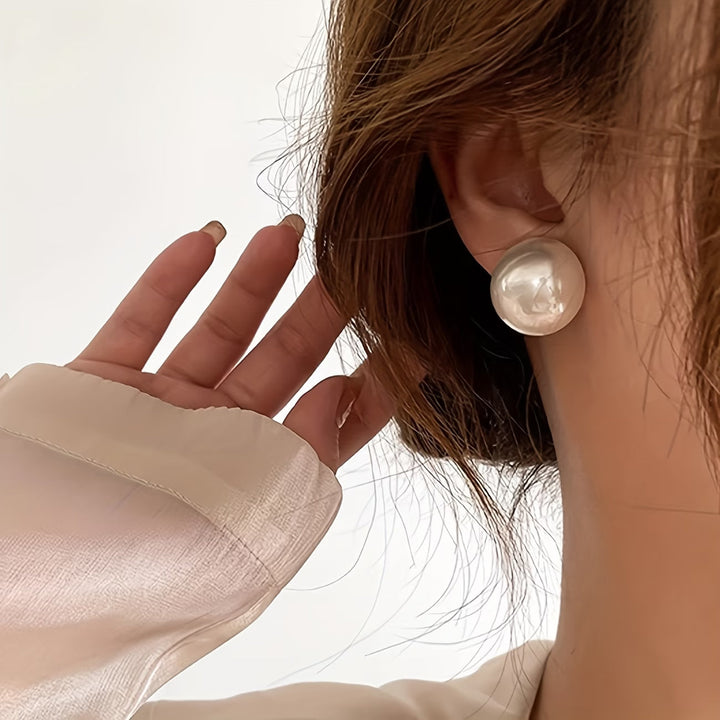 Les boucles d'oreilles dormeuses à perle statement